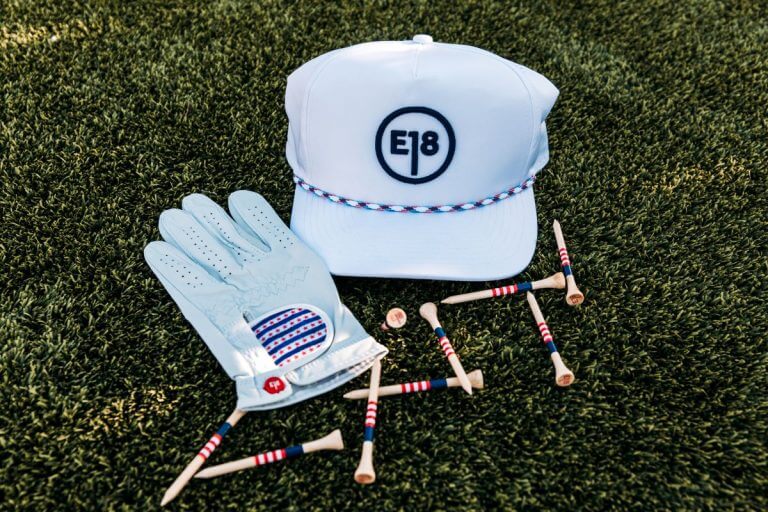 white golf gloves and cap on grass